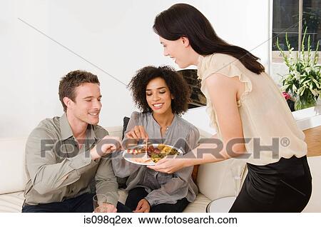 A woman offering friends canapes View Large Photo Image Stock Photo - A woman offering friends canapes. Fotosearch