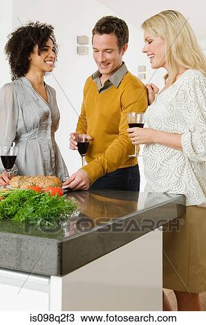 Friends having red wine at a dinner party View Large Photo Image Stock Image - Friends having red wine at a dinner party. Fotosearch