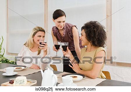Friends having red wine at a dinner party View Large Photo Image Stock Image - Friends having red wine at a dinner party. Fotosearch