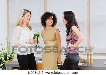 Picture - Friends talking at a dinner party. Fotosearch