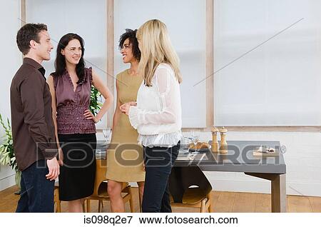 Stock Photo - Friends talking at a dinner party. Fotosearch