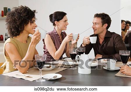Stock Photograph - Friends talking over coffee. Fotosearch