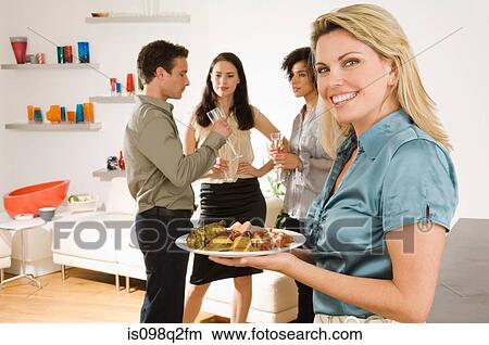 Portrait of a woman holding a plate of canapes View Large Photo Image Picture - Portrait of a woman holding a plate of canapes. Fotosearch