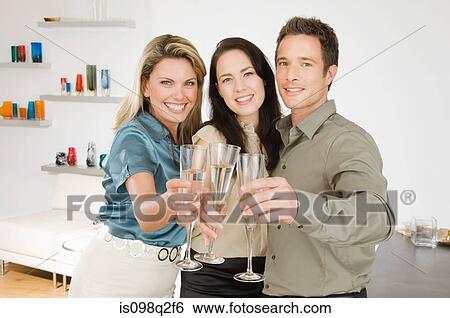Stock Photograph - Portrait of friends toasting with champagne. Fotosearch