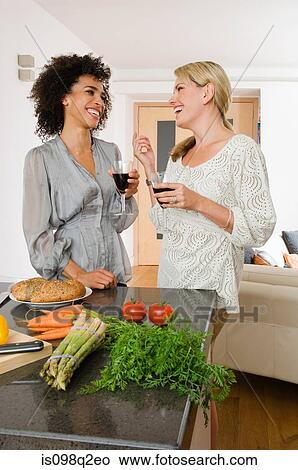Picture - Two women having red wine. Fotosearch