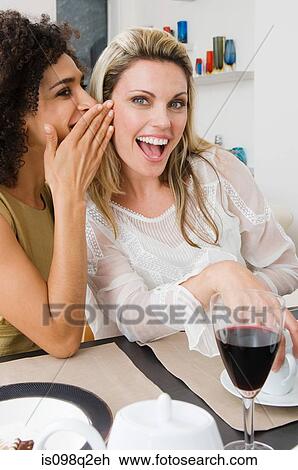 Two women whispering View Large Photo Image Stock Image - Two women whispering. Fotosearch