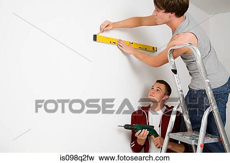 Stock Photo - A gay couple doing diy together. Fotosearch