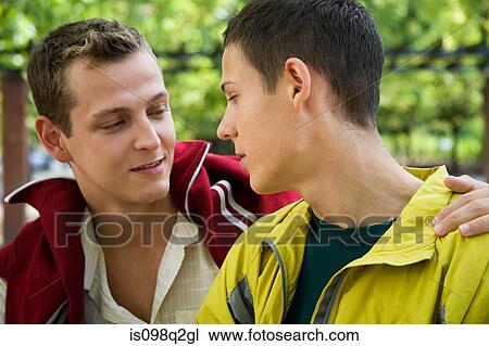 A gay couple looking at each other View Large Photo Image Stock Image - A gay couple looking at each other. Fotosearch