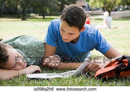 A gay couple reading a newspaper in the park View Large Photo Image Stock Photograph - A gay couple reading a newspaper in the park. Fotosearch