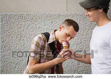 A gay couple sharing an icecream View Large Photo Image Stock Image - A gay couple sharing an icecream. Fotosearch