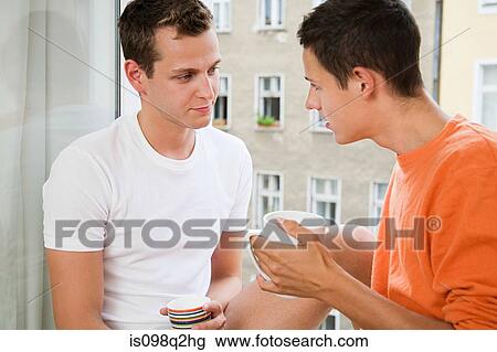 Stock Image - A gay couple talking. Fotosearch
