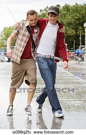 Stock Photograph - A gay couple walking together. Fotosearch