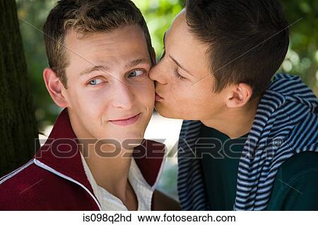 A man kissing his partner on the cheek View Large Photo Image Stock Image - A man kissing his partner on the cheek. Fotosearch