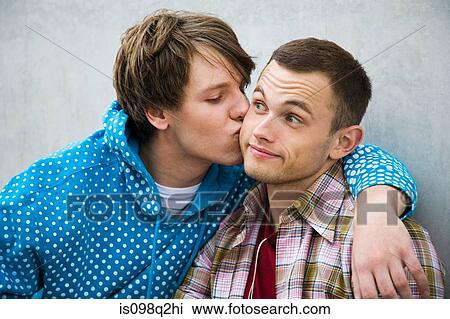 A man kissing his partner on the cheek View Large Photo Image Stock Image - A man kissing his partner on the cheek. Fotosearch