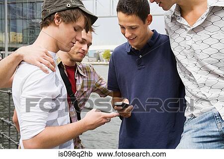 Friends exchanging phone numbers View Large Photo Image Stock Image - Friends exchanging phone numbers. Fotosearch