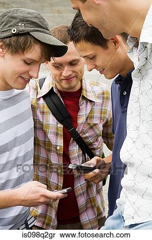 Friends exchanging phone numbers View Large Photo Image Stock Photography - Friends exchanging phone numbers. Fotosearch