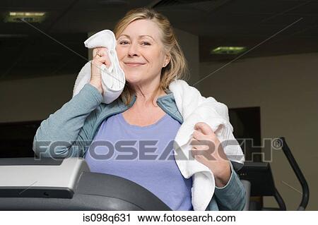 A mature woman drying her face View Large Photo Image Stock Image - A mature woman drying her face. Fotosearch