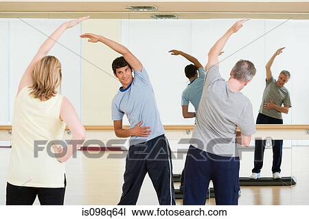 A personal trainer teaching an exercise lesson View Large Photo Image Stock Image - A personal trainer teaching an exercise lesson. Fotosearch