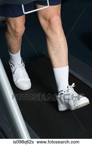 Mature man walking on a treadmill View Large Photo Image Stock Photograph - Mature man walking on a treadmill. Fotosearch
