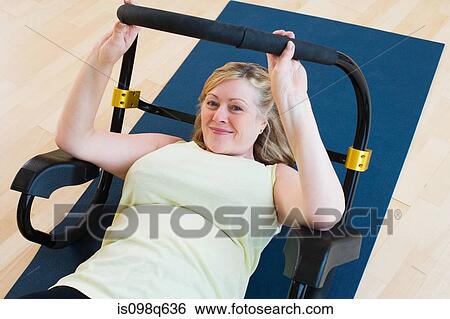 Stock Photograph - Mature woman doing sit ups. Fotosearch