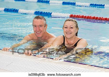 Portrait of a couple in a swimming pool View Large Photo Image Stock Image - Portrait of a couple in a swimming pool. Fotosearch
