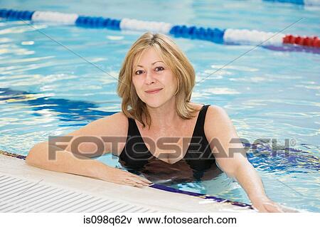 Stock Photo - Portrait of a woman in a swimming pool. Fotosearch