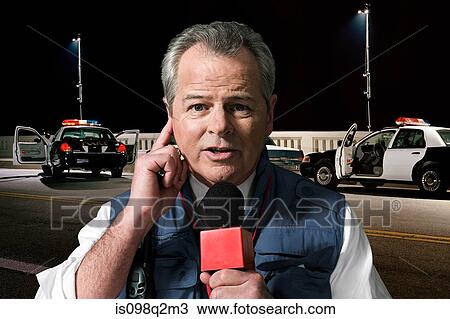 Stock Image - News presenter at crime scene. Fotosearch