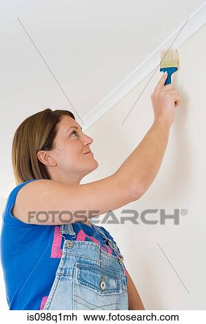 Stock Image - A decorator painting coving. Fotosearch