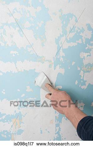 A decorator scraping wallpaper off a wall View Large Photo Image Stock Photo - A decorator scraping wallpaper off a wall. Fotosearch