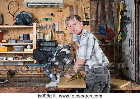 A mature man working with a table saw View Large Photo Image Stock Image - A mature man working with a table saw. Fotosearch