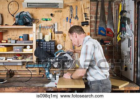 A mature man working with a table saw View Large Photo Image Stock Image - A mature man working with a table saw. Fotosearch