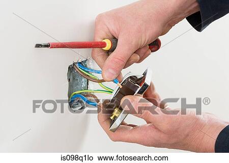 An electrician fixing a socket View Large Photo Image Picture - An electrician fixing a socket. Fotosearch