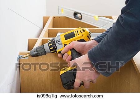 Man screwing a shelf to a wall View Large Photo Image Stock Image - Man screwing a shelf to a wall. Fotosearch