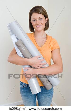 Young woman rholding wallpaper View Large Photo Image Stock Image - Young woman rholding wallpaper. Fotosearch