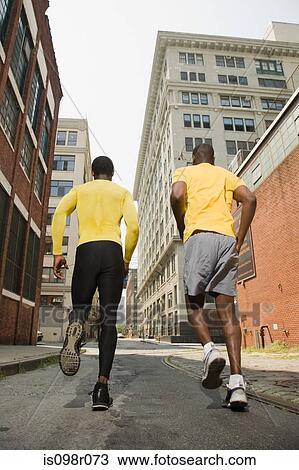 Stock Image - Runners in urban setting. Fotosearch