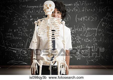 Boy and skeleton in front of blackboard View Large Photo Image Stock Image - Boy and skeleton in front of blackboard. Fotosearch
