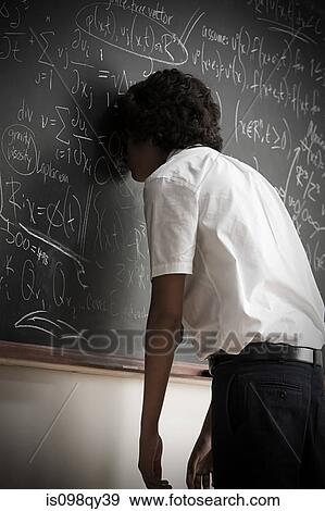 Stock Photo - Boy leaning on blackboard. Fotosearch