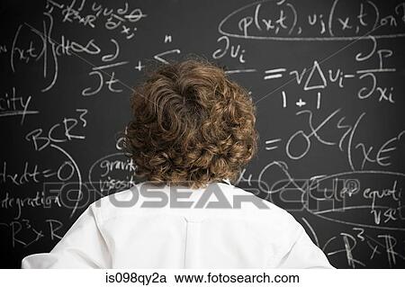 Stock Image - Boy looking at blackboard. Fotosearch