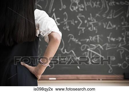 Stock Photo - Girl by blackboard. Fotosearch