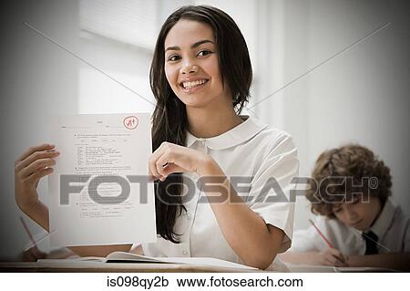 Stock Image - Girl with exam paper. Fotosearch