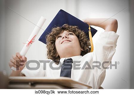 Stock Image - Graduating boy looking up. Fotosearch