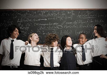 Stock Image - Students in front of blackboard. Fotosearch