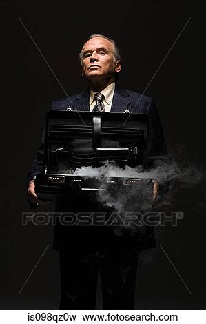 Businessman with smoking briefcase View Large Photo Image Stock Photo - Businessman with smoking briefcase. Fotosearch