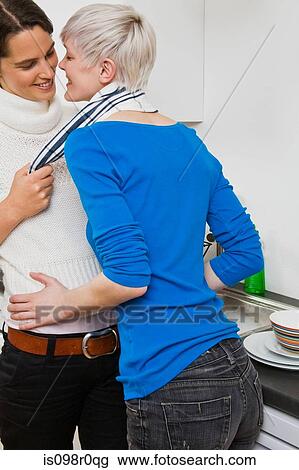 Stock Image - A lesbian couple fooling around. Fotosearch