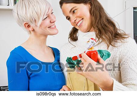 A lesbian couple giving christmas presents View Large Photo Image Stock Photograph - A lesbian couple giving christmas presents. Fotosearch