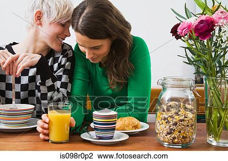 Stock Image - A lesbian couple having breakfast. Fotosearch