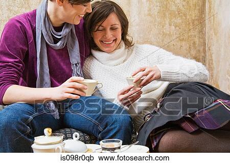 A lesbian couple having coffee View Large Photo Image Stock Image - A lesbian couple having coffee. Fotosearch