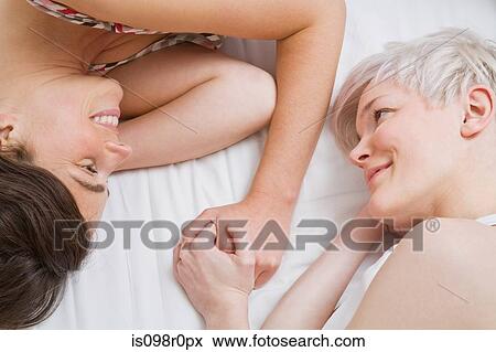 Stock Photo - A lesbian couple in bed. Fotosearch