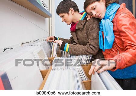 Stock Photograph - A lesbian couple looking at records. Fotosearch