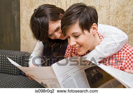 A lesbian couple reading a paper View Large Photo Image Stock Image - A lesbian couple reading a paper. Fotosearch
